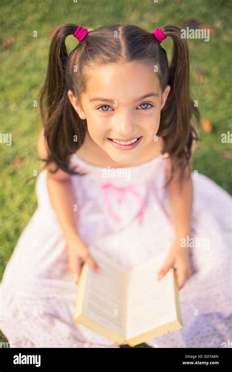 Young Girl Reading Book In Park Stock Photo Alamy