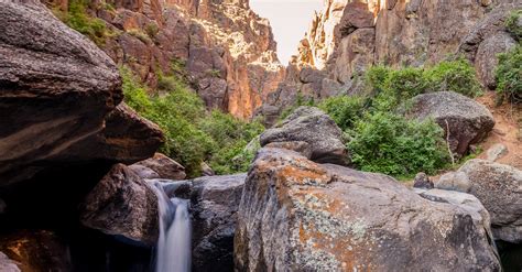 Rocky Ravine With Small Waterfall Against Cloudless Sky · Free Stock Photo