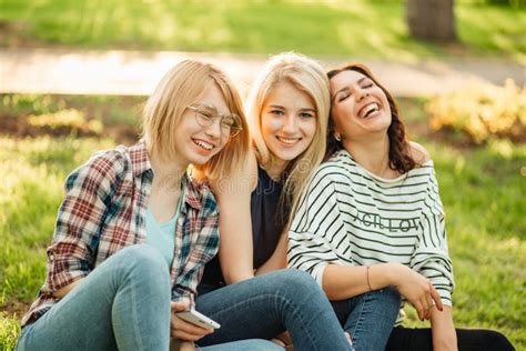 Three Cute Hippie Girl Sitting Outdoors Best Friends Having Fun And Laughing Stock Image