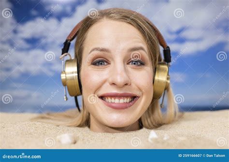 Woman Buried In Sand On Beach With Headphones Stock Image Image Of