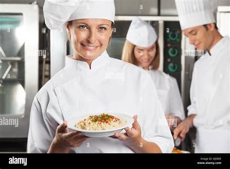 Happy Female Chef Presenting Dish Stock Photo Alamy