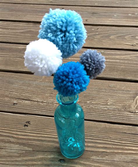 Note that you can totally make these using thicker yarn, it'll just have a different feel and perhaps, you won't be able to fit in as many flowers but they turn out pretty all the same. Pom Pom Yarn Flowers - Sometimes Homemade