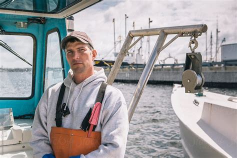 Portrait Of Commercial Fisherman On His Boat In Port By Stocksy