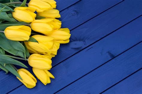 Premium Photo Blue Tulip Flowers On Wooden Backdrop