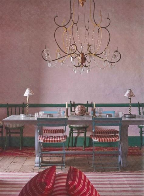 An Intricate Chandelier Hangs Over A Dining Table And Chairs In Minn