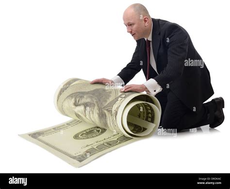 Taking Care Of Money A Man Rolling Up A Large 100 Dollar Bill Isolated