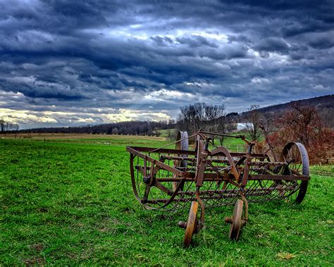Antique Hay Rake Under As Stormy Sky Photograph By Chris Bordeleau