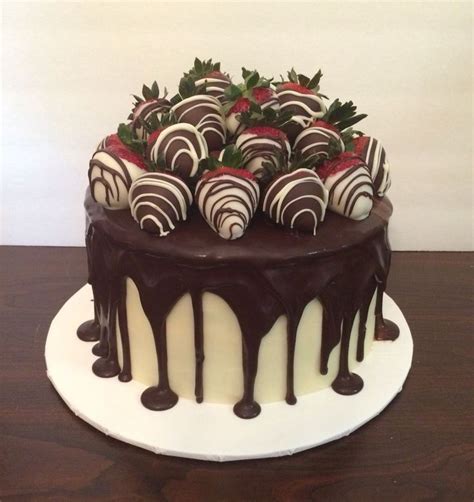 white and dark chocolate ganache elegant birthday cake with chocolate covered strawberries by