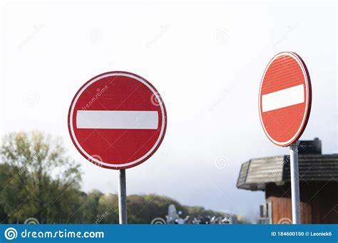 Two Red Circular Traffic Signs Or Roadsign With A White Bar Indicating