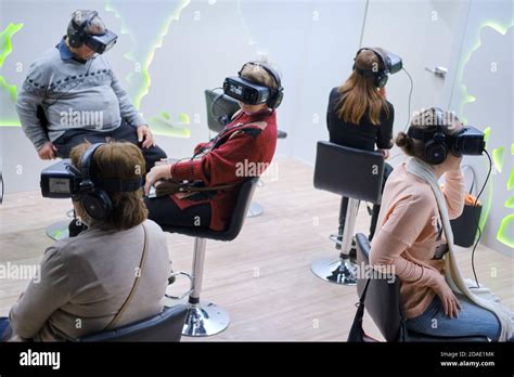 Men And Women Wearing Oculus Rift Gear Vr Virtual Reality Helmet Stock