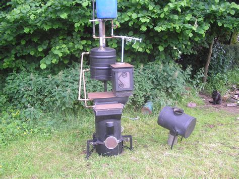 I traced the outline of the vent pipe on to the lid of the bucket and cut this hole . Welsh Biochar making Water Heater | Improved Biomass ...