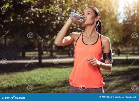 Delighted Girl Drinking Water After Morning Exercises Stock Image
