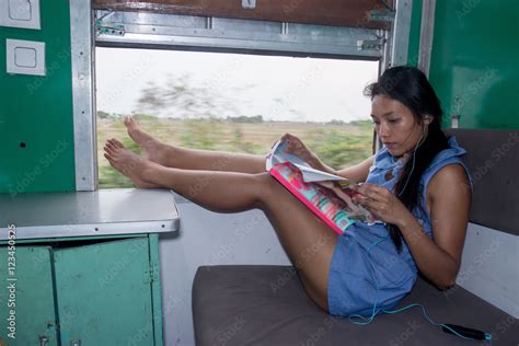 Asian Girl Sitting In A Train With Her Legs On Window Myanmar Burma