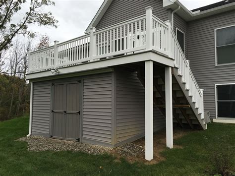 A traditional wooden she shed kit from amazon. Fiberon Castle Gray Deck with storage shed under deck ...