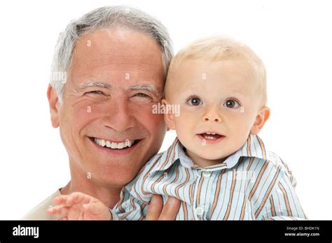 Studio Portrait Of Grandfather Holding Grandson Stock Photo Alamy