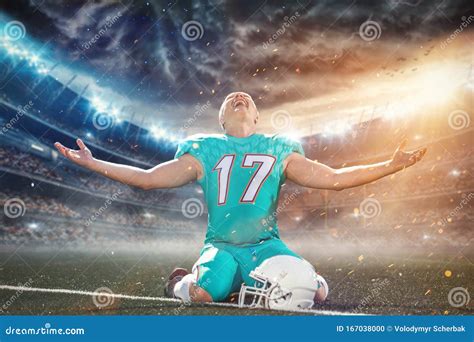 american football player celebrating after scoring a touchdown on the field of big modern