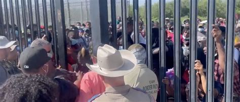 video shows hundreds of migrants swarm through border gates immediately apprehended the daily