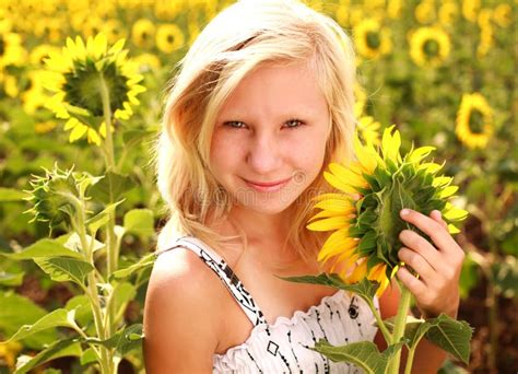 Happy Smiling Teen Girl With Sunflower In Summer Field Stock Image