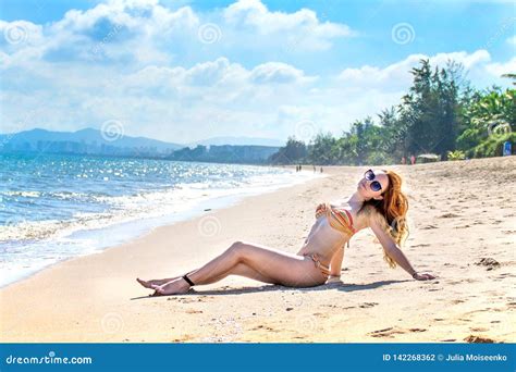 Beautiful Girl In Bikini Posing On A Deserted Beach White Sand