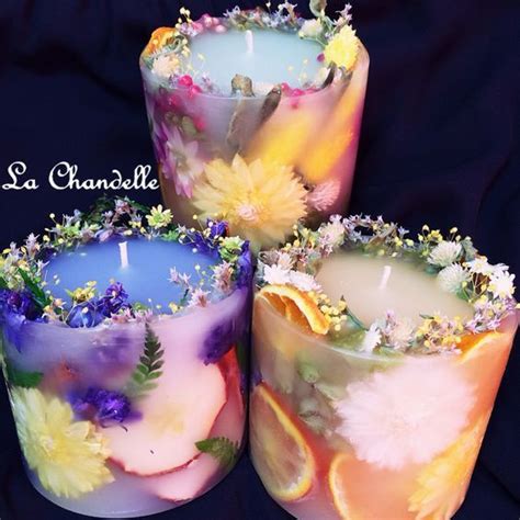 Put Candle In A Smaller Container And Add Flowers To The Sides And Add