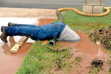 Watch Utility Worker Goes Head First Into Muddy Water To Fix Pipe
