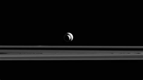 Cassini Probe Takes Cosmic Bulls Eye Of Saturn Moons Enceladustethys