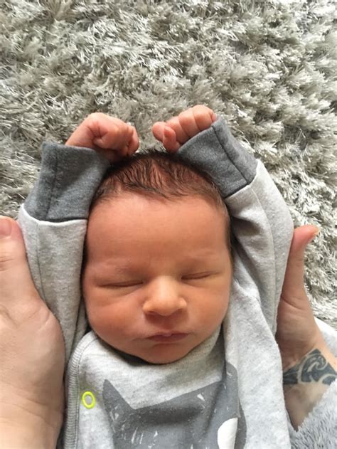 A Newborn Baby Cannot Touch Their Hands Together Over The Top Of Their