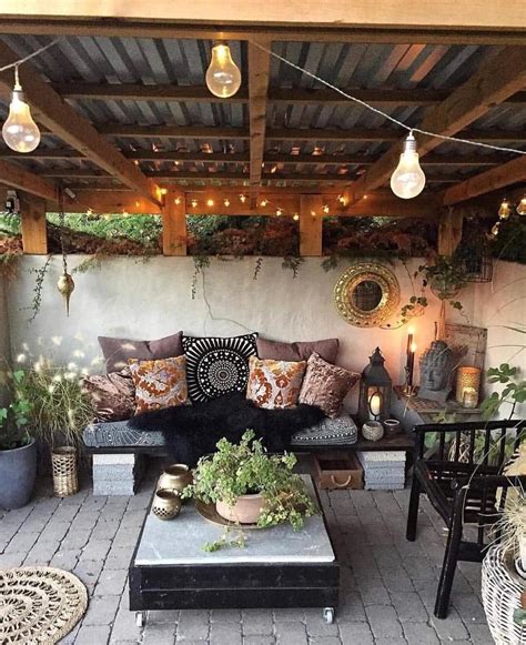 An Outdoor Living Area With Couches Tables And Potted Plants