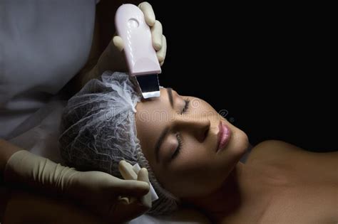 Woman In Professional Beauty Spa Salon During Ultrasonic Facial Cleansing Procedure Stock Image