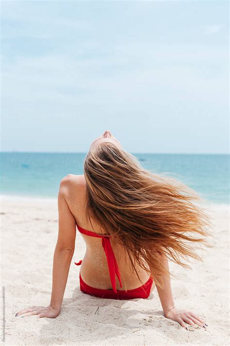 Woman Sit On Beach And The Wind Blows Her Hair By Stocksy Contributor Alexandra Bergam Stocksy