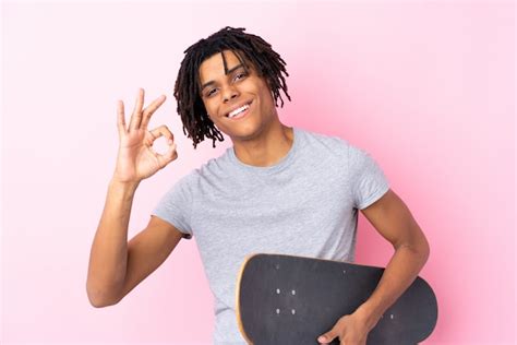 Premium Photo Young African American Skater Man Over Pink Wall