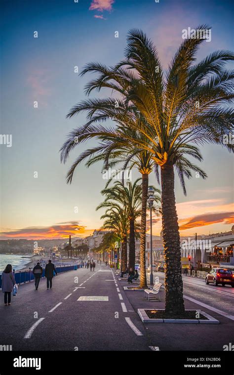 People Walking Along The Promenade Des Anglais In Nice At Sunset Stock