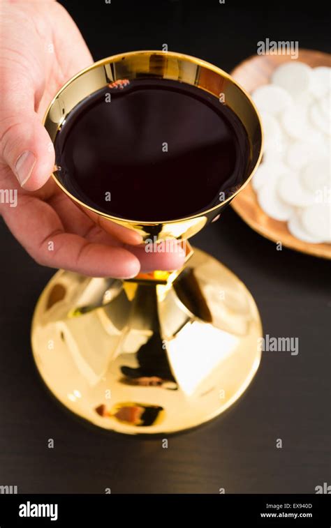 Christian Holy Communion Mans Hand Holding Gold Chalice With Wine