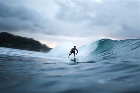 Person Riding On Surfboard · Free Stock Photo