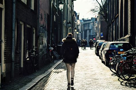 Person Walking Down The Streets Of Utrecht Netherlands Image Free