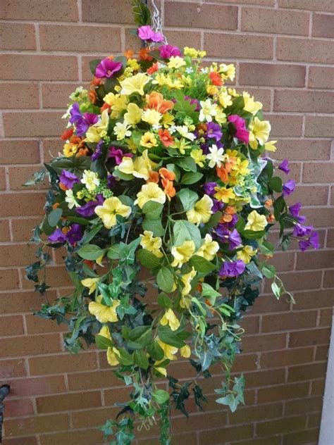 Hang these flower baskets both indoors and outdoors. Hanging basket with artificial yellow petunias | garden ...