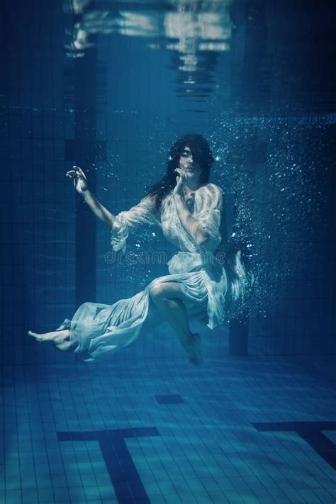 Woman Wearing Beautiful Dress Underwater In A Swimming Pool Stock Image