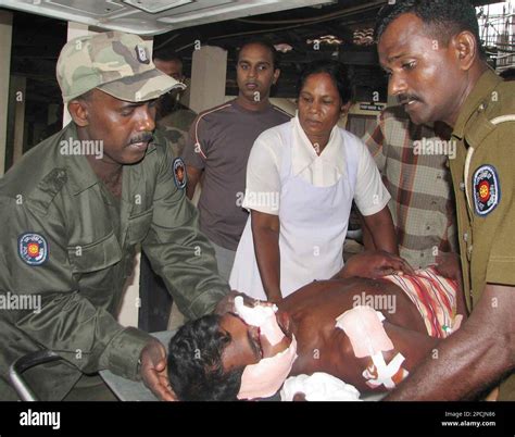 Sri Lankan Police And Army Officers Help A Wounded Civilian At A