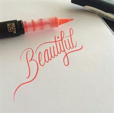 The Word Beautiful Written In Red Ink On A Piece Of Paper Next To A Pen