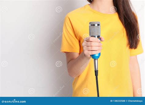 Young Woman Holding Microphone On Color Background Stock Photo Image