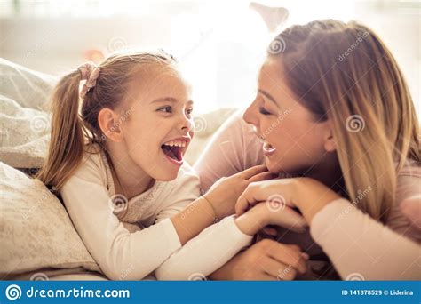 Mother And Daughter Having Conversation In Bed Stock Image - Image of ...