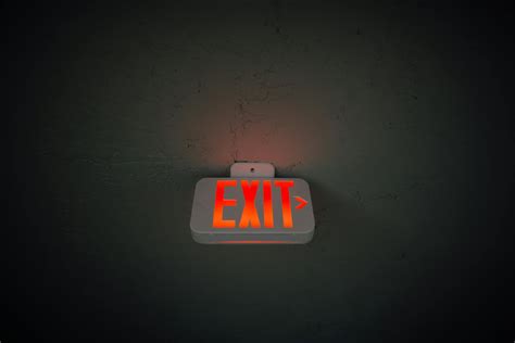Exit Sign Hanging On Ceiling In Public Area · Free Stock Photo