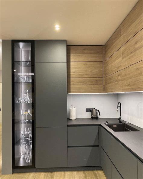 A Modern Kitchen With Wooden Cabinets And Stainless Steel Counter Tops