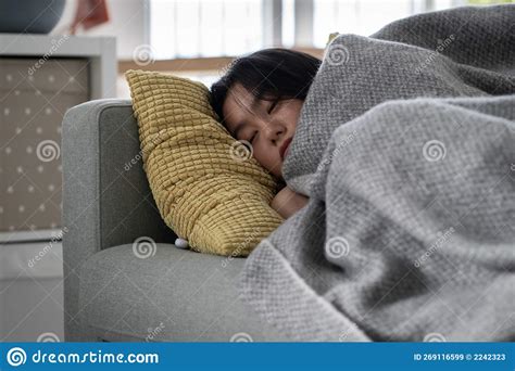 sick asian woman sleeping on sofa under blanket at home recovering from flu stock image image