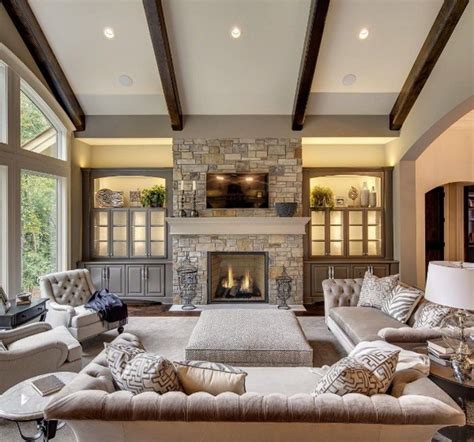 Amazing living room features a gray linen sectional facing a round marble top coffee table facing an accent wall tiled with white stone lined with a flatscreen gorgeous living room features blue accent chairs draped with orange hermes throw blankets next to a wall of built in bookcases, with books. 20+ Captivating Vaulted Ceiling Design Ideas For Living ...