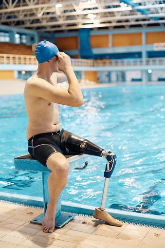 Athletic Amputee Adjusting His Swimming Goggles While Preparing For A