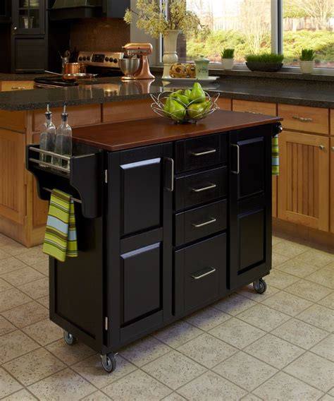Hung from a white plank ceiling, darlana lanterns light a blue kitchen island fitted with turned legs and a white and gray marble countertop seating cherner counter stools facing a farm sink with a chrome gooseneck faucet. Kitchen Island & Carts | The Home Depot Canada