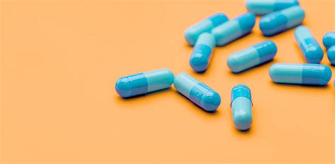 blue antibiotic capsule pills spread on yellow background antib domisanus