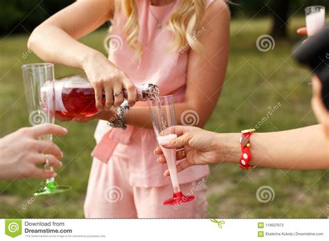 Womans Pours Champagne In Glasses At Picnic Party Stock Photo Image