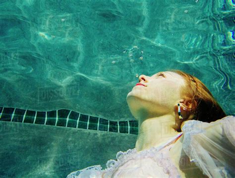 Caucasian Woman Wearing Dress Swimming Underwater Stock Photo Dissolve